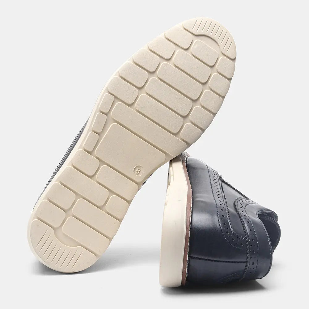 Dark navy leather men’s brogue casual loafer sneaker with cream-colored rubber sole and stitched detailing.