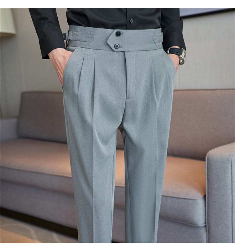 Light gray mens pleated drape casual trousers with a structured waistband featuring two black buttons and matching belt loops.