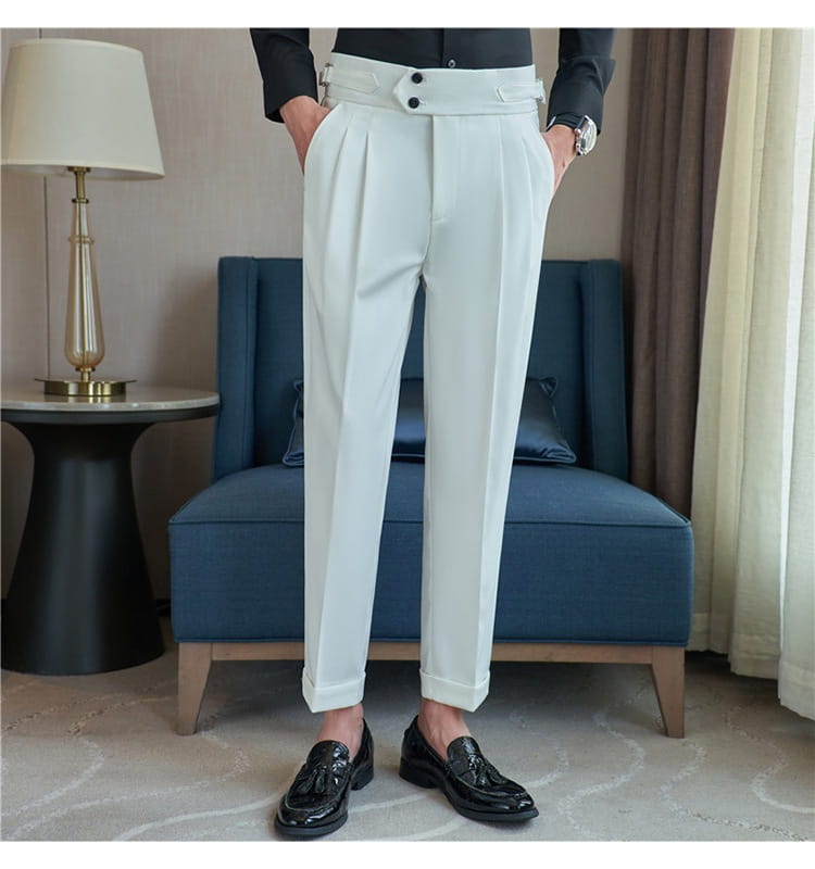 White tailored mens pleated drape casual trousers featuring a high waist, double-button closure, and cuffed hems.