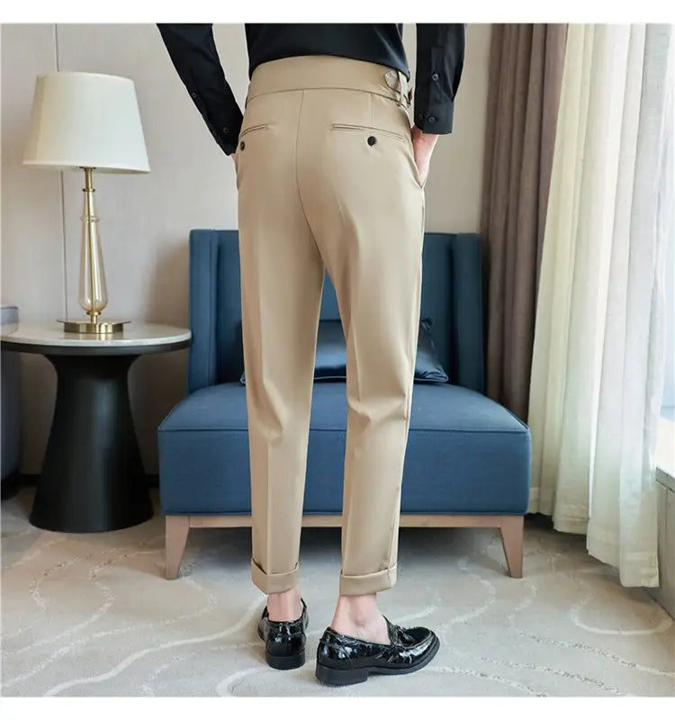 Beige mens pleated drape casual trousers with a sleek modern cut and subtle side pockets.