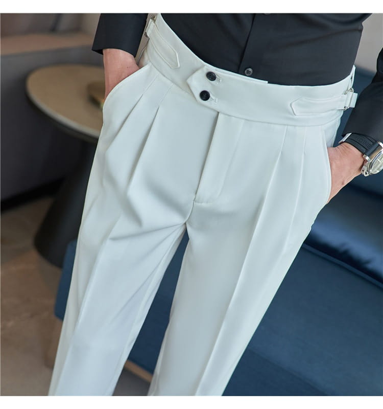Light gray mens pleated drape casual trousers with a wide waistband featuring black buttons and belt loops.