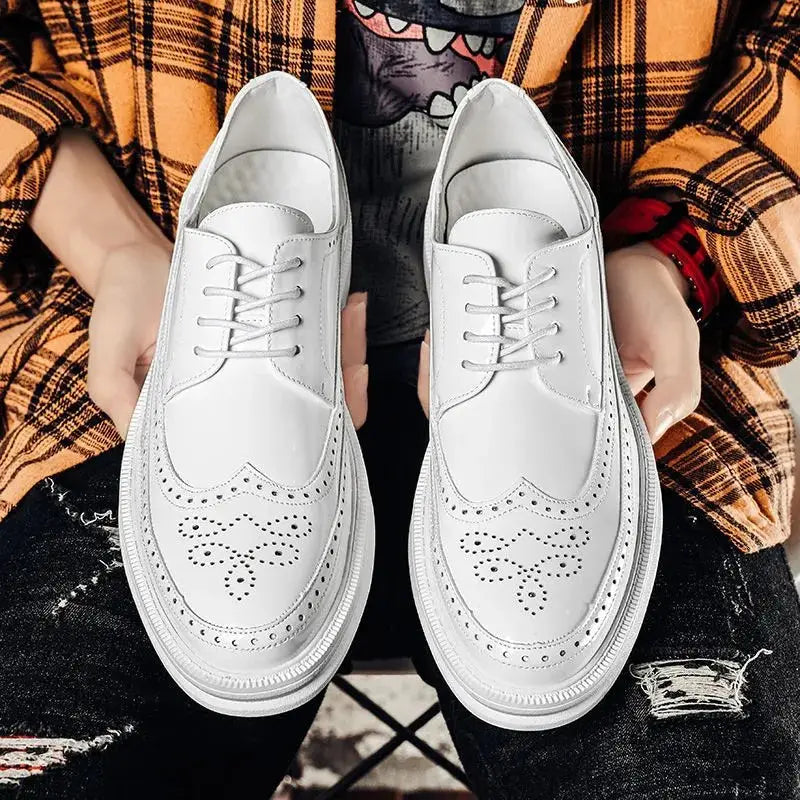 White leather men’s brogue oxford shoes with perforated detailing and a chunky sole suitable for business casual wear.