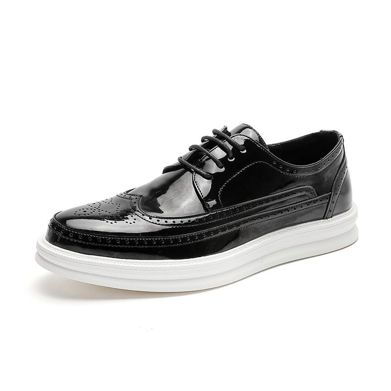 Black patent leather men’s brogue oxford shoe with a white chunky platform sole suitable for business casual wear.