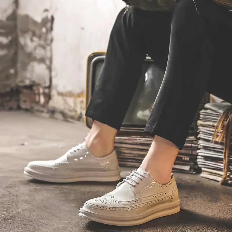 Men’s cream-colored leather brogue Oxford shoes with chunky sole and perforated detailing suitable for business casual wear.
