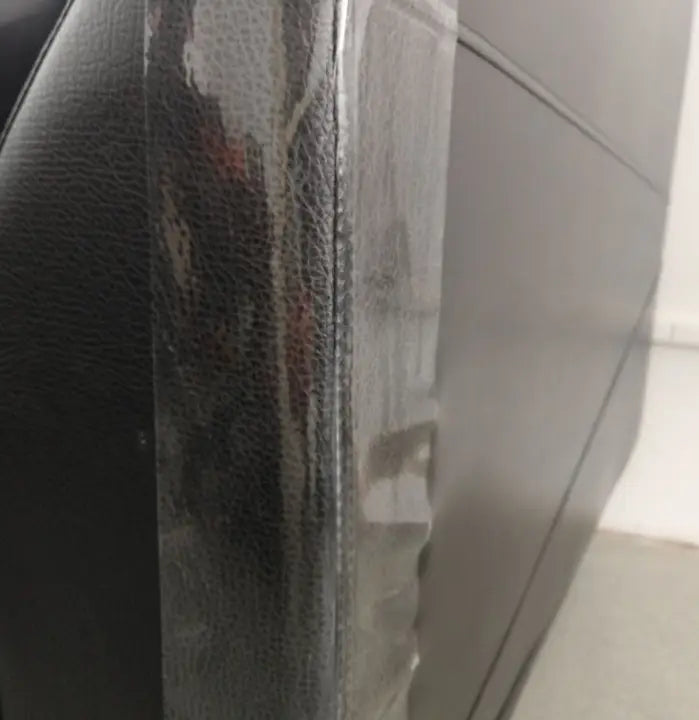 black textured leather back side of a cat scratch protector furniture guard 30x45cm 2 pack showing visible wear and tear