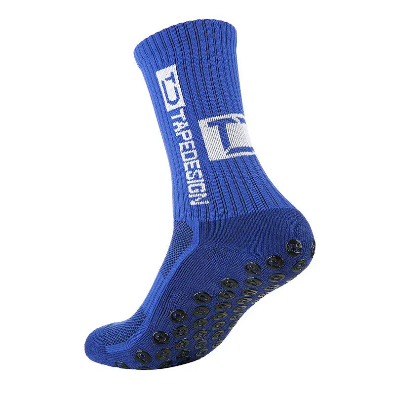 Chaussette de football antidérapante bleue dotée de pastilles antidérapantes noires sur la semelle et d’un logo Tradesign blanc au niveau de la manchette