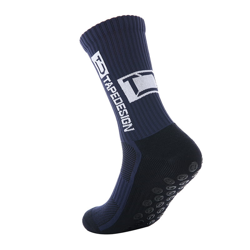 Chaussettes de football antidérapantes bleu marine et noires avec marquage tredesign blanc sur le côté, conçues pour une meilleure adhérence et un confort accru.