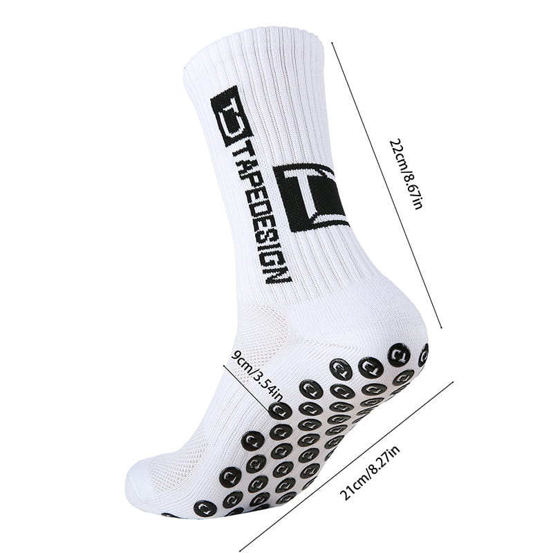 Chaussette de football de sport antidérapante blanche avec pastilles antidérapantes noires sur la semelle et un logo Trapedesign imposant le long du côté.