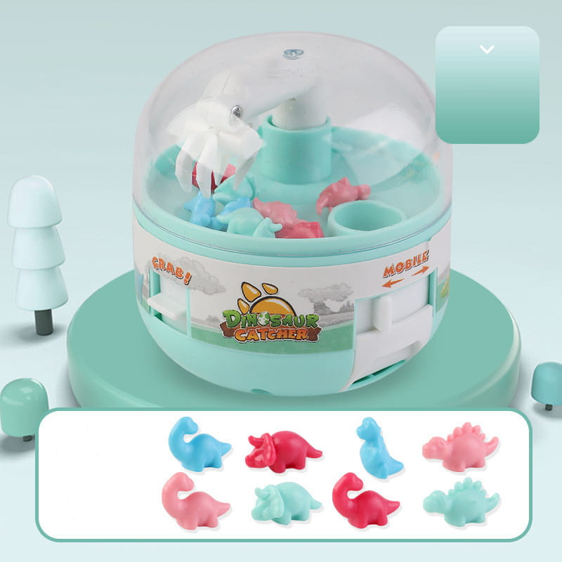 A translucent teal plastic dinosaur mini gashapon machine kids claw toy with a clear dome containing colorful silicone dinosaurs labeled dinosaur catcher on its side.