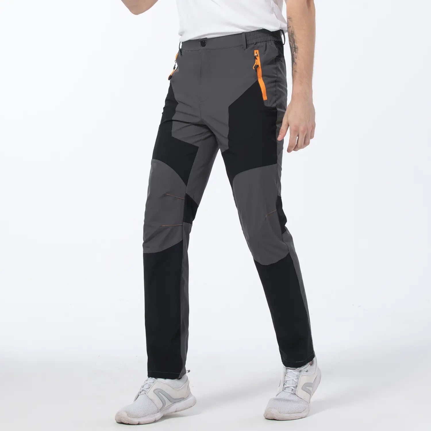 Men quick dry tactical hiking pants in gray and black with orange zipper accents designed for durability and comfort.