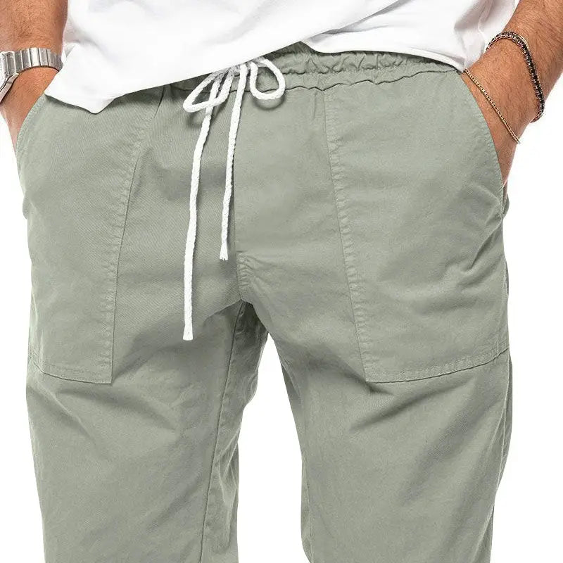 Joggeurs décontractés pour hommes à jambe fuselée vert olive, avec cordon de serrage blanc et poches latérales conçues pour le confort et le style.