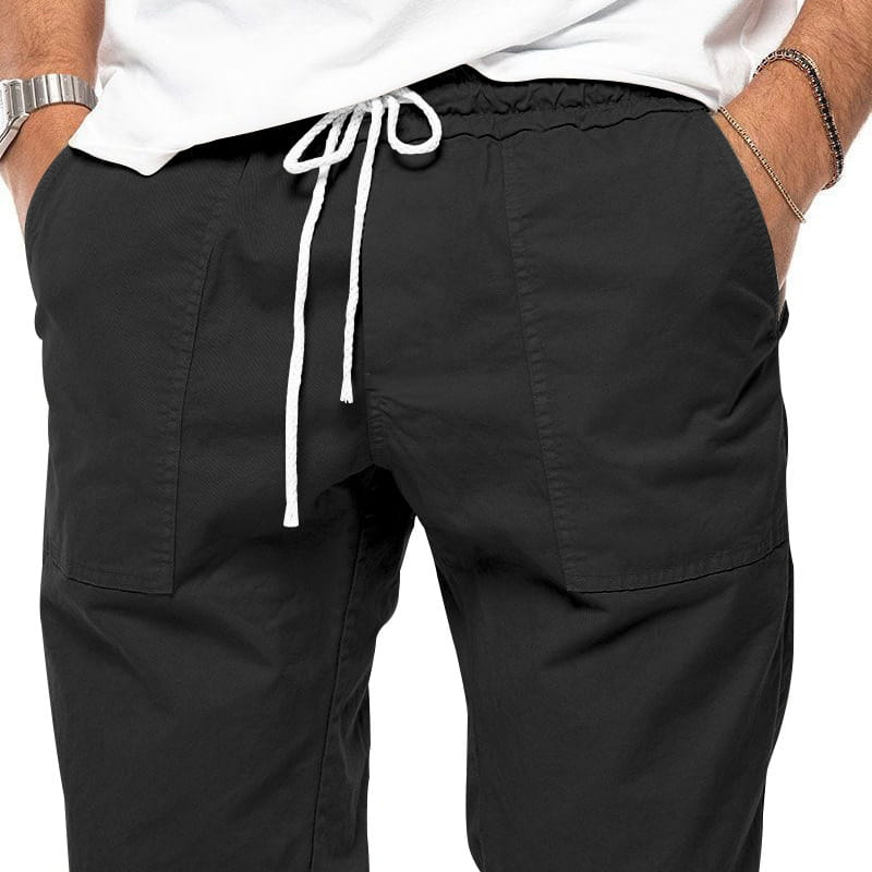 Joggeurs décontractés pour hommes à jambe fuselée noirs, avec un cordon de serrage blanc et des poches latérales, fabriqués dans un tissu confortable