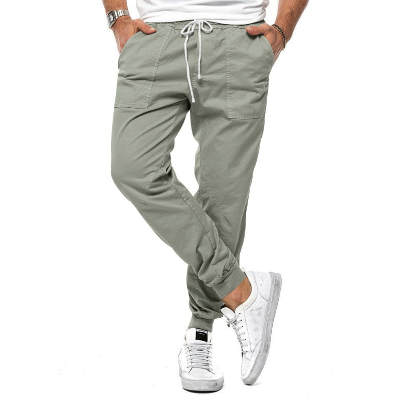 Joggeurs décontractés pour hommes à jambe fuselée vert olive, avec des poches latérales, une taille à cordon de serrage et des poignets élastiques, conçus pour un port quotidien confortable.