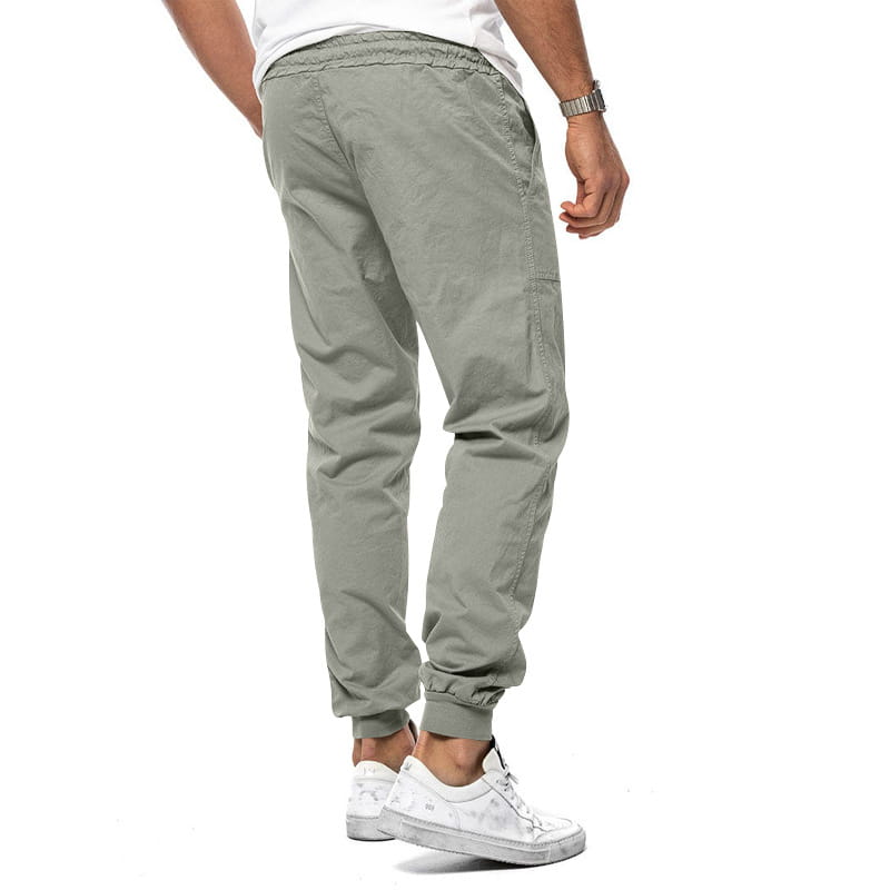 Joggeurs décontractés pour hommes à jambe fuselée vert olive, avec une ceinture élastique et des chevilles resserrées, conçus pour le confort et le style.