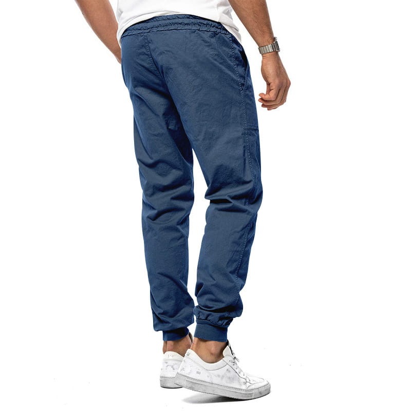 Joggeurs décontractés pour hommes à jambe fuselée bleu marine en coton, avec une ceinture élastique et un cordon de serrage, des jambes fuselées et des poignets côtelés.