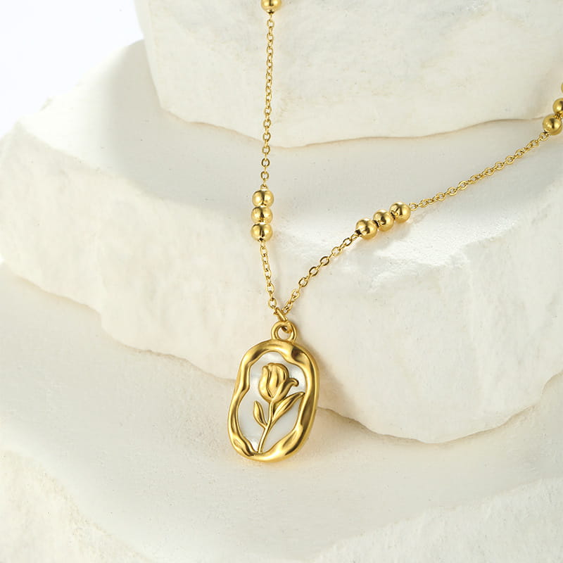 18k gold plated stainless steel necklace featuring a gold-toned oval pendant with a delicate tulip design and small spherical beads along the chain.