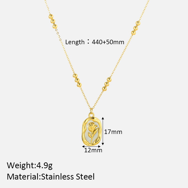 A delicate 18k gold plated stainless steel necklace featuring a small oval-shaped pendant with an engraved tulip design and subtle white shell inlay.