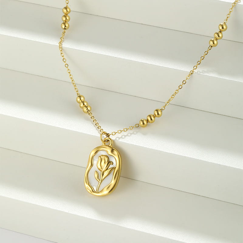 18k gold plated stainless steel necklace featuring a gold-toned delicate tulip pendant encased in an oval frame with small spherical bead accents along the chain.