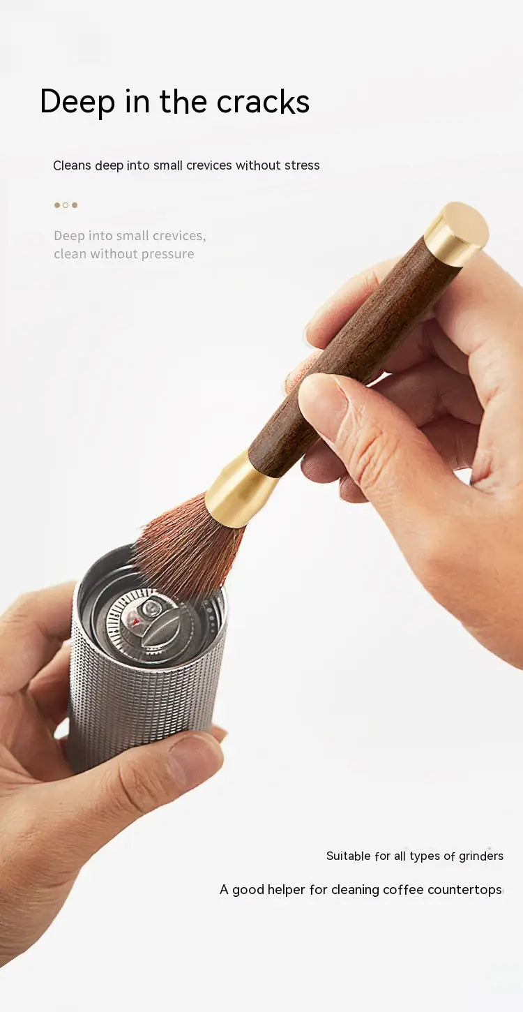 A sleek metallic cylindrical coffee grinder cleaning brush with a textured surface and a gold-toned brass bristle brush handle from the coffee grinder cleaning brush wood and brass 5 pack.