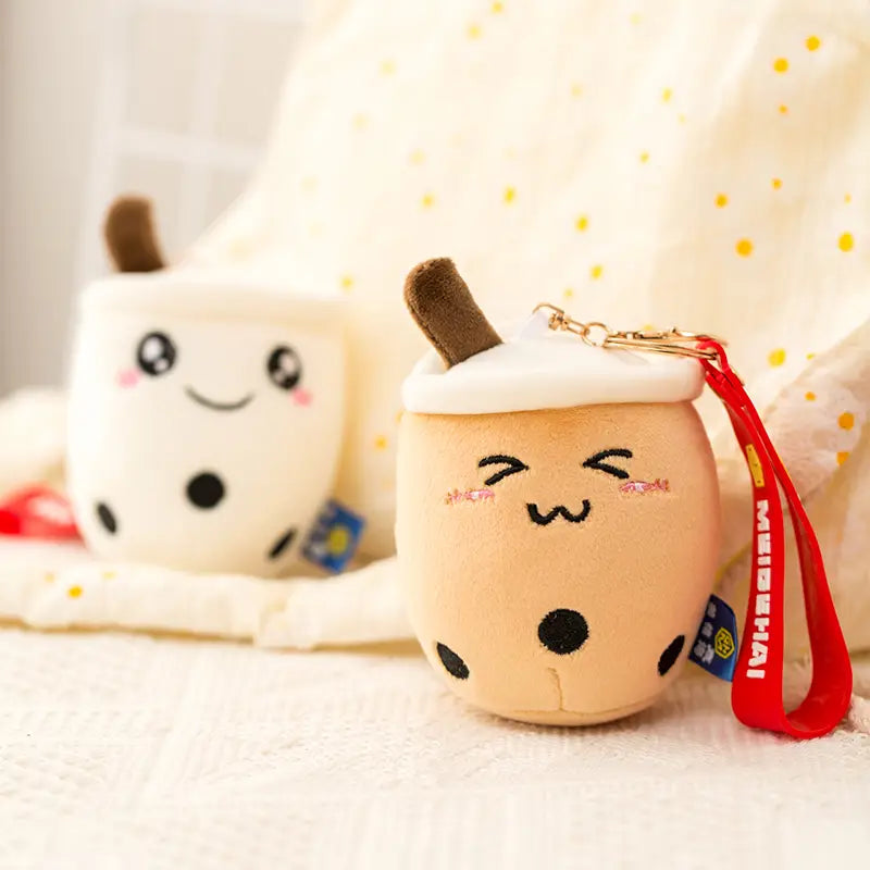 Cute beige plush boba tea keychain with black tapioca pearls brown straw and embroidered smiling face milk tea cup doll pendant.