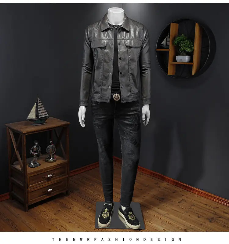 Men’s black faux leather motorcycle jacket with button front and two chest pockets.