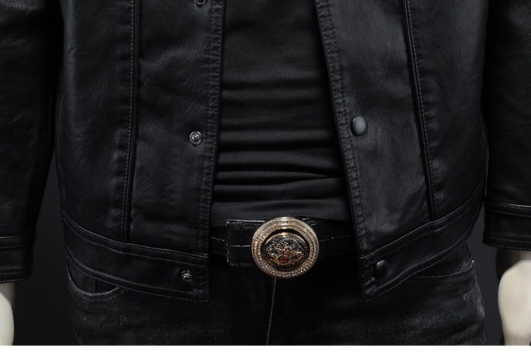 Men’s black faux leather button front motorcycle jacket with silver-toned circular buckle featuring an intricate embossed design.