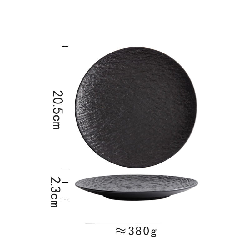 Black ceramic round plate with a textured stone-like Nordic rock pattern surface and a slightly raised rim.