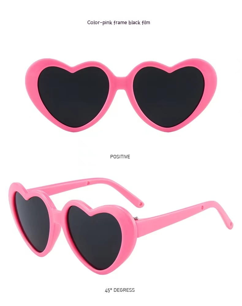 En la imagen se muestran unas gafas de sol de moda con forma de corazón color rosa, con lentes negros, diseñadas para mascotas y muñecas.