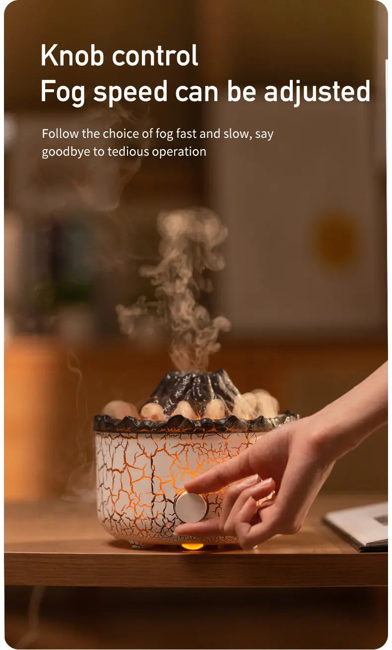 A crackled white and orange ceramic volcano essential oil diffuser humidifier with a black volcanic peak emitting mist from its top.