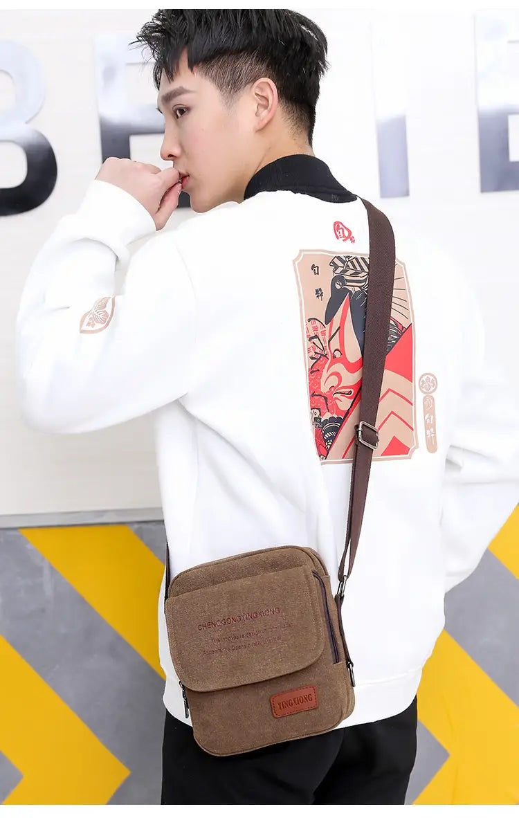 Brown canvas crossbody business shoulder bag for men with a rectangular flap and stitched details.