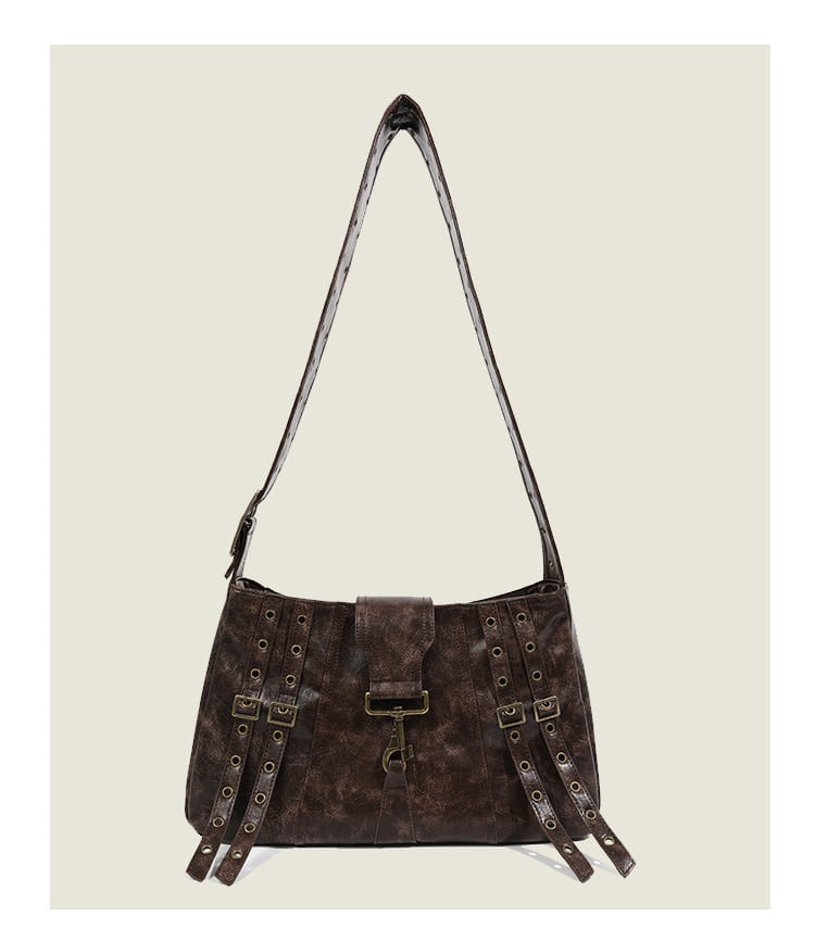 Dark brown distressed leather punk crossbody bag with metallic buckles rivets and strap details.