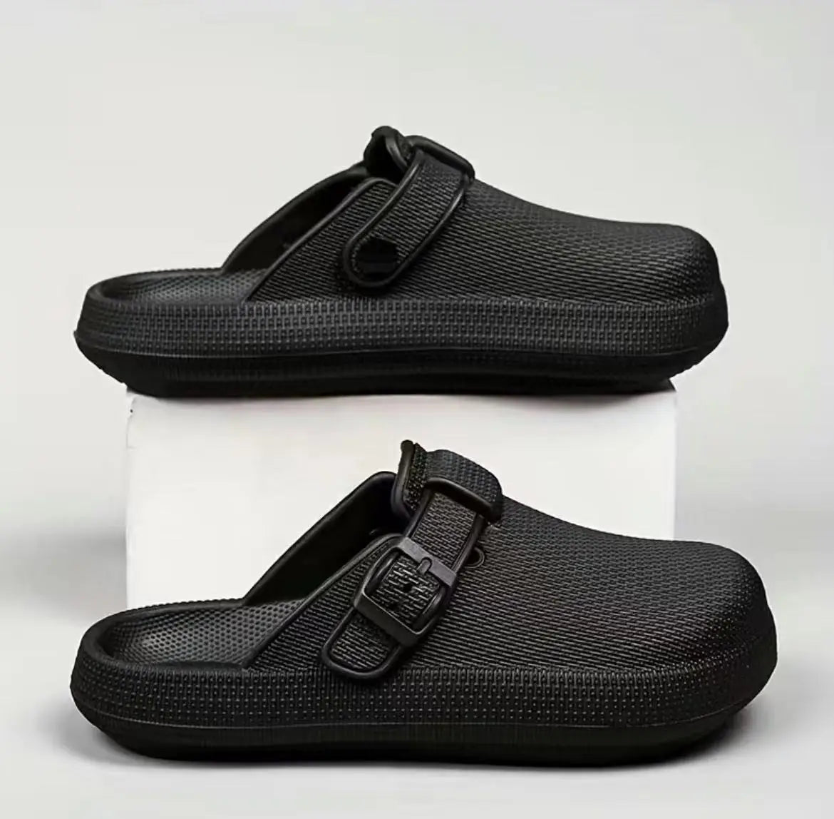 Black mesh slip-on clog slippers for men with a thick rubber sole and adjustable strap buckle