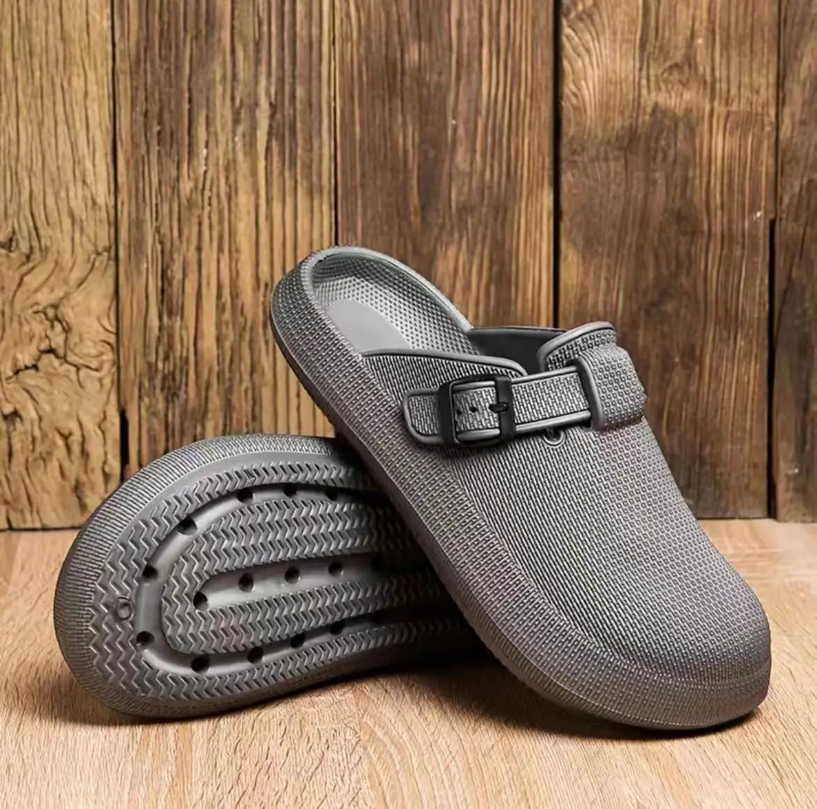 Men lightweight mesh clog slippers in gray featuring a black adjustable buckle strap and a textured rubber sole.
