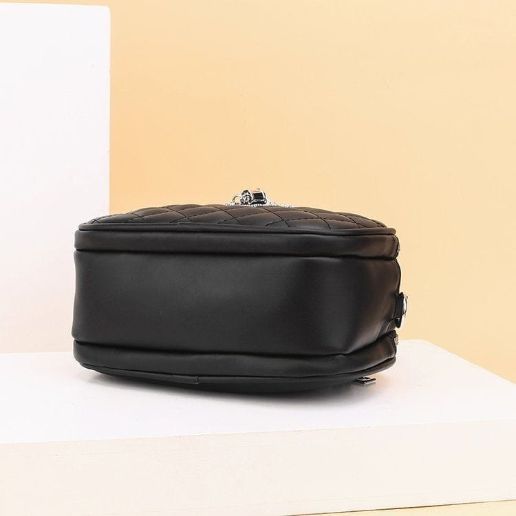 Black quilted faux leather crossbody bag with silver-toned chain clasp and silver hardware chain strap.