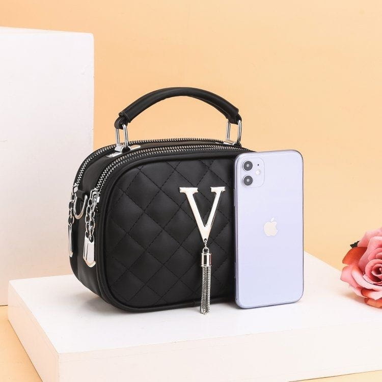 Black quilted handbag with silver v monogram tassel detail and silver hardware chain strap.