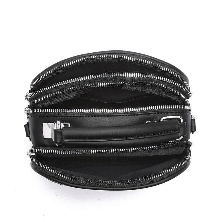 Black circular quilted handbag with silver hardware chain strap featuring multiple zippers and a top handle for versatile carrying options.