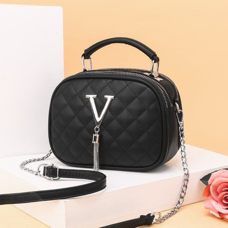 Black quilted handbag with silver v logo and chain strap featuring silver hardware