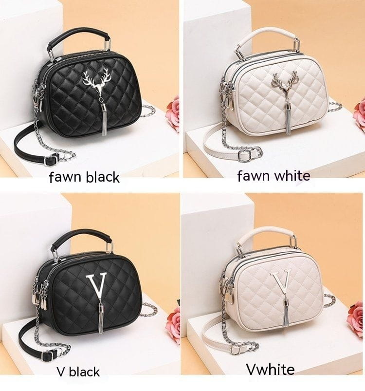 Quilted handbag with silver hardware chain strap featuring a metallic v emblem, available in black or white faux leather.