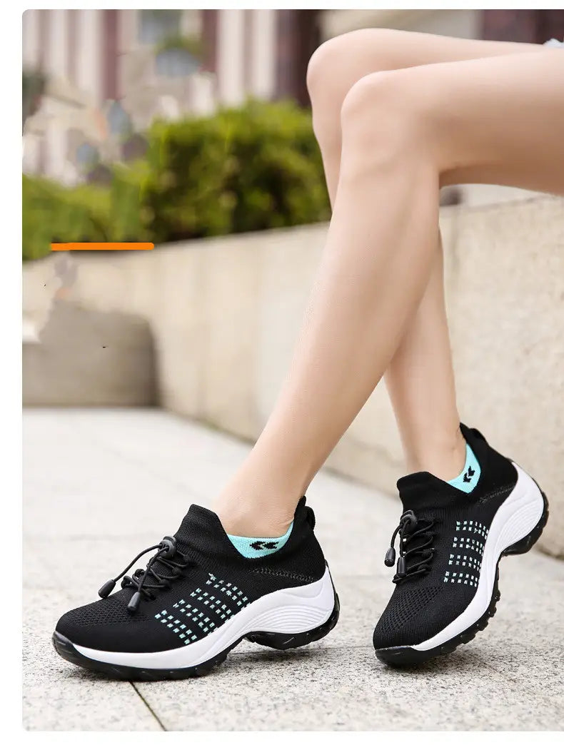 women’s lightweight fly knit casual sneakers in black and light blue with a breathable mesh upper, perforated design for ventilation, and a white rubber sole.