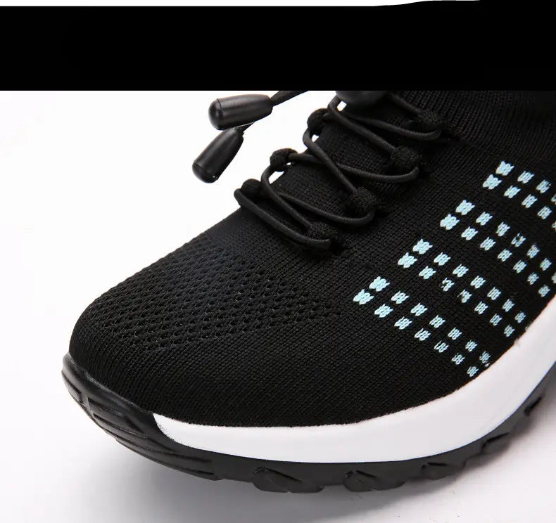 Women’s lightweight fly knit casual sneaker in black with light blue embroidered patterns and a white midsole.