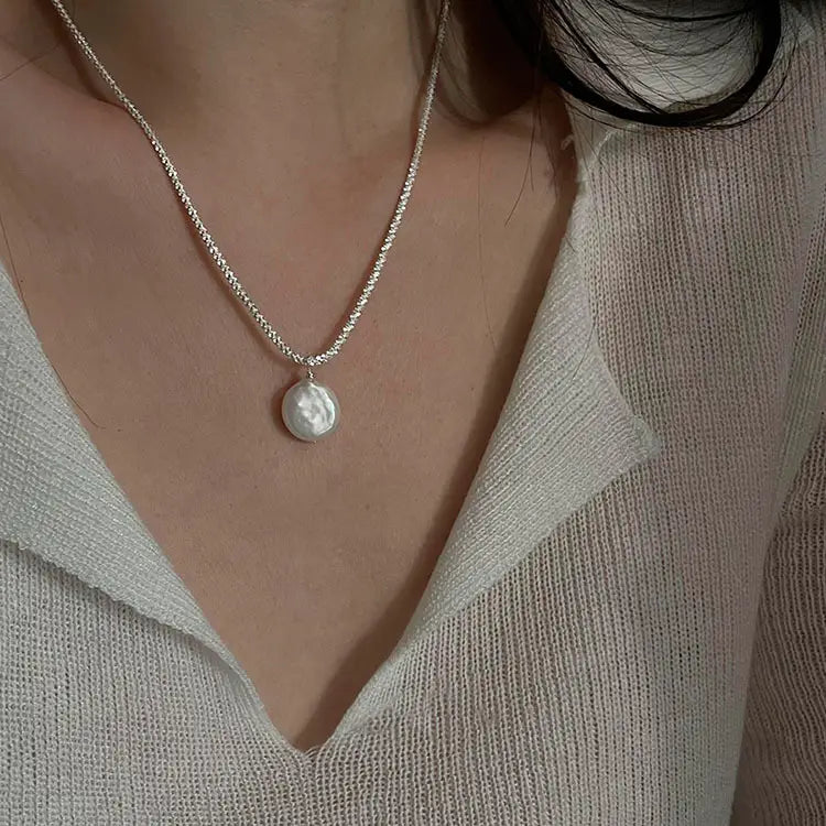 Sterling silver baroque pearl starry sky necklace featuring a delicate silver chain with a single lustrous white baroque pearl pendant.