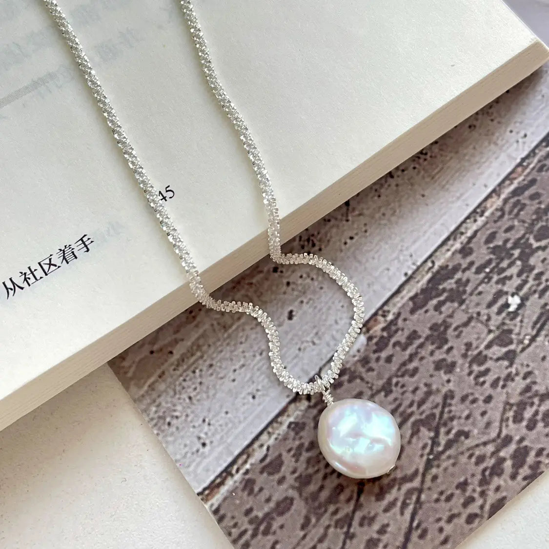 A sterling silver delicate chain necklace featuring a single lustrous white baroque pearl pendant titled baroque pearl starry sky necklace.