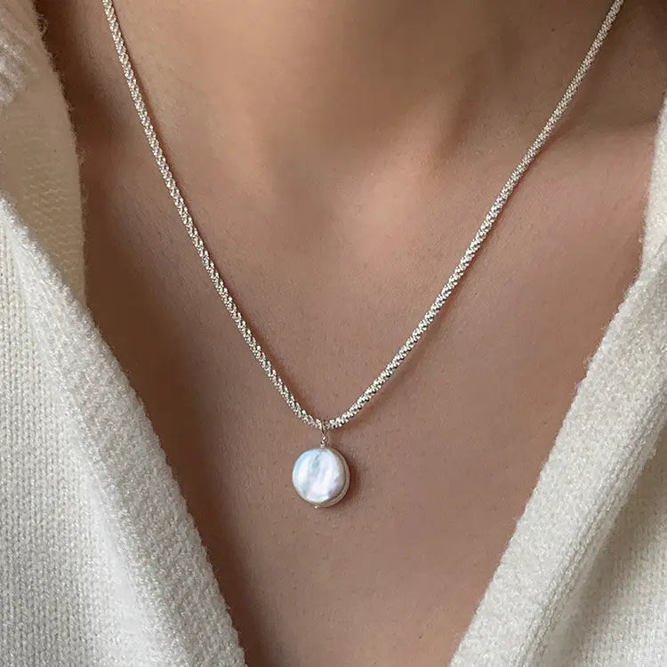 Sterling silver baroque pearl starry sky necklace featuring a delicate silver chain with a single round lustrous white pearl pendant.