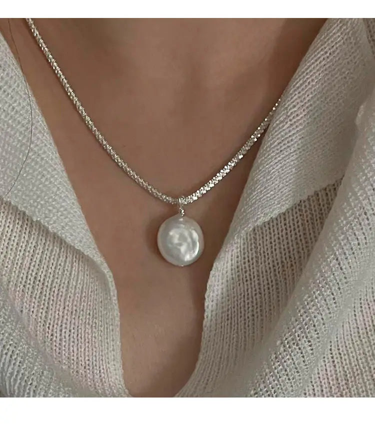 A sterling silver baroque pearl starry sky necklace featuring a delicate silver chain with a single lustrous white pearl pendant.