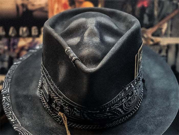 Black leather Plush Skull cowboy hat featuring intricate silver-toned embroidery and a decorative band.