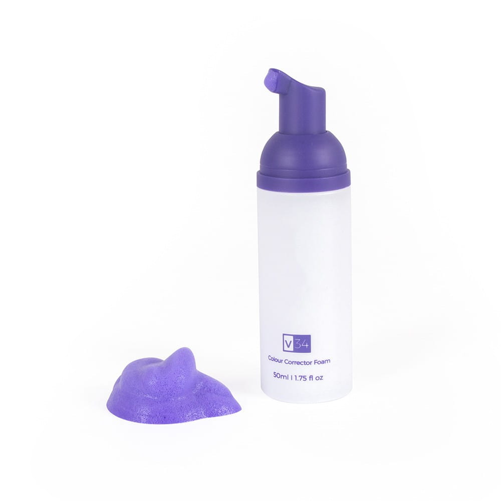 Un flacon blanc et élégant avec un distributeur de pompe pourpre, portant la mention « v34 colour corrector foam » ; contient 50 ml de mousse violet vibrante pour le blanchiment des dents et la correction des couleurs, à utiliser.