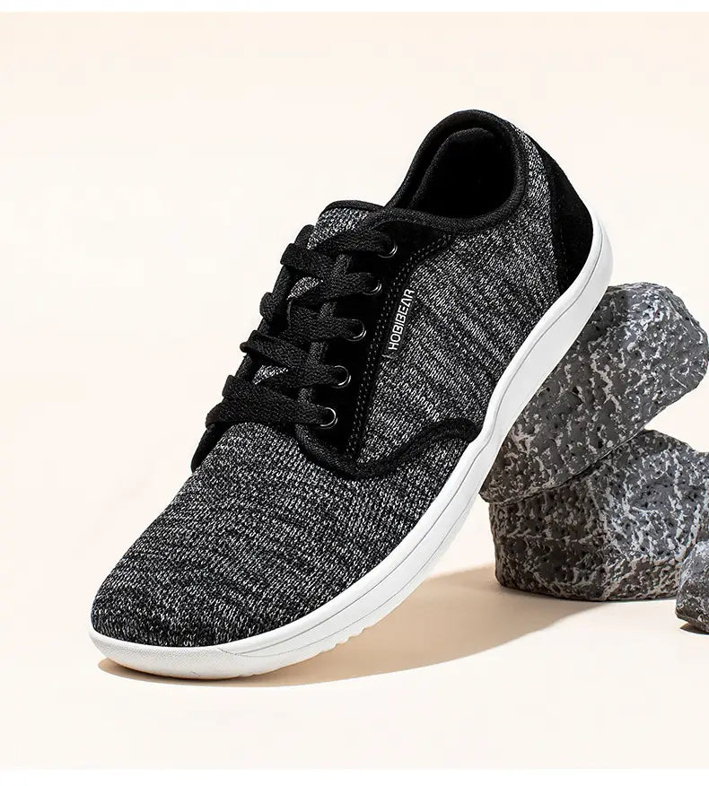 Chaussures de sport décontractées en daim unisexes gs6968 avec dessus en toile texturée noire et grise et semelle en caoutchouc blanche.