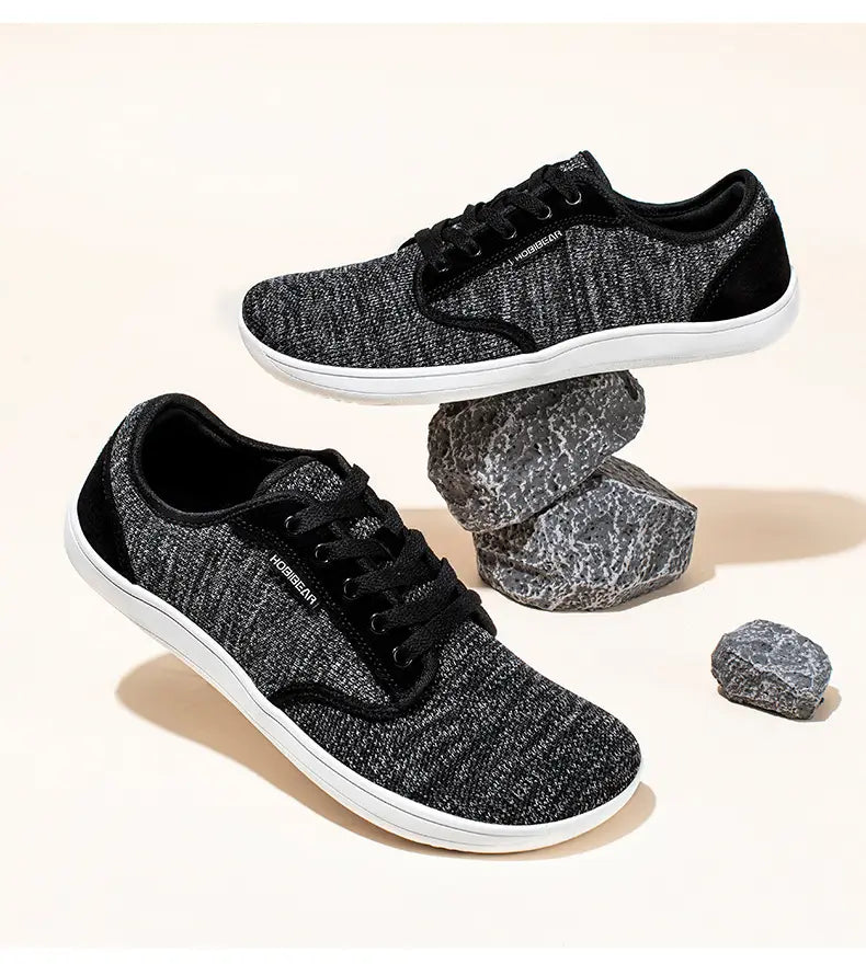 Chaussures de sport décontractées en daim unisexes gs6968 en toile texturée noire et grise avec semelles en caoutchouc blanches.