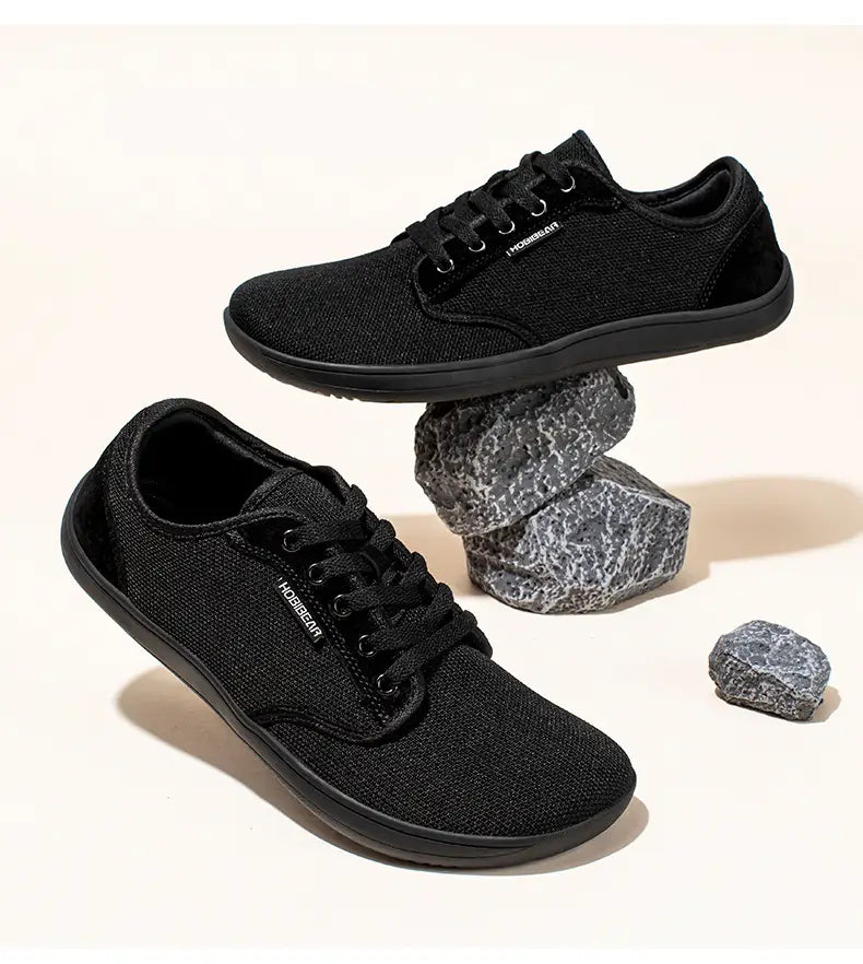 Baskets de sport décontractées en toile tissée noire unisexes avec lacets noirs, semelle en caoutchouc élégante et étiquette de marque hobeeear sur le côté, modèle gs6968.