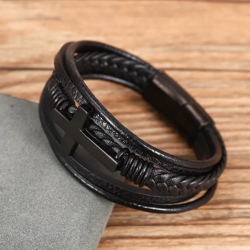 Black leather braided multi-strand bracelet with a central black cross accent and magnetic clasp.